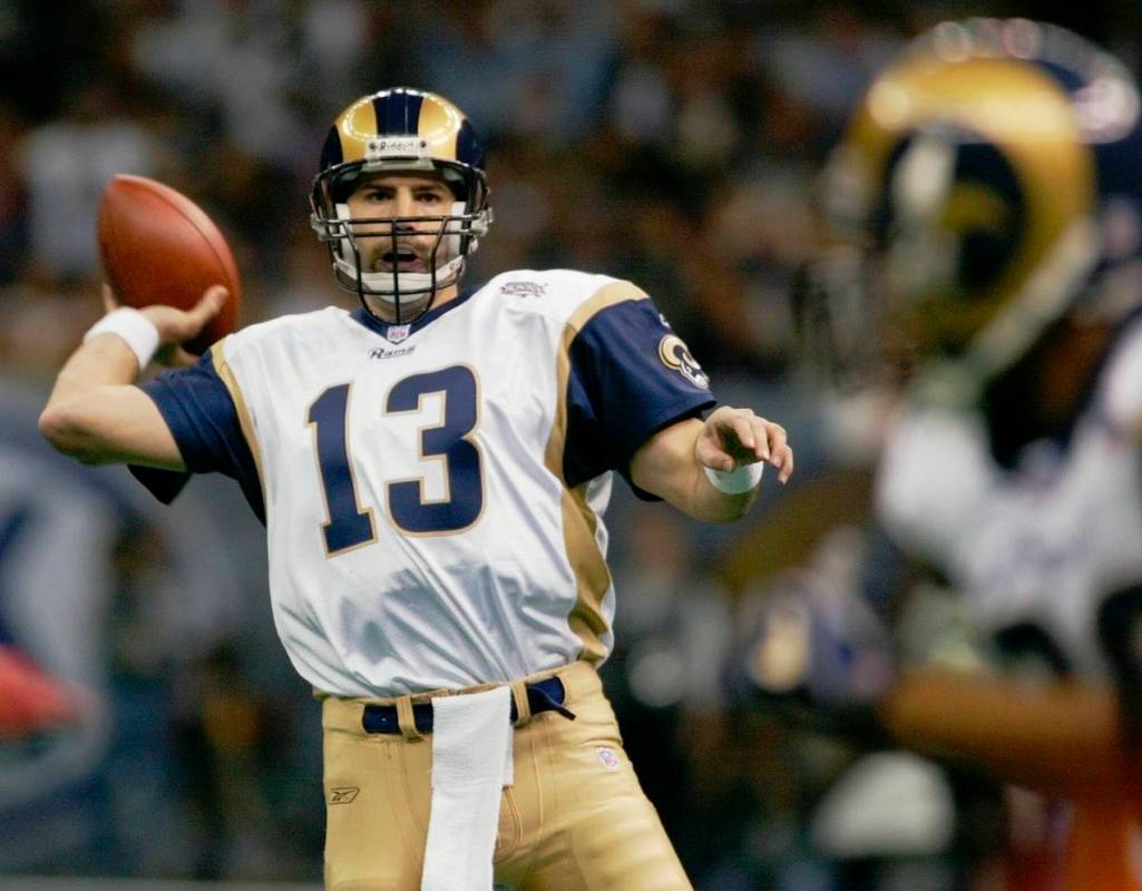 FILE- In this Feb. 3, 2002, file photo, St. Louis Rams quarterback Kurt Warner looks to pass to ...