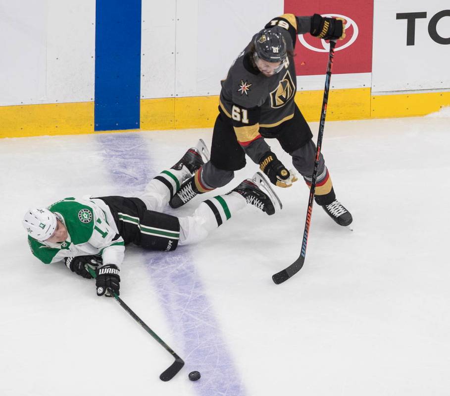 Dallas Stars' Mattias Janmark (13) is tripped up by Vegas Golden Knights' Mark Stone (61) durin ...