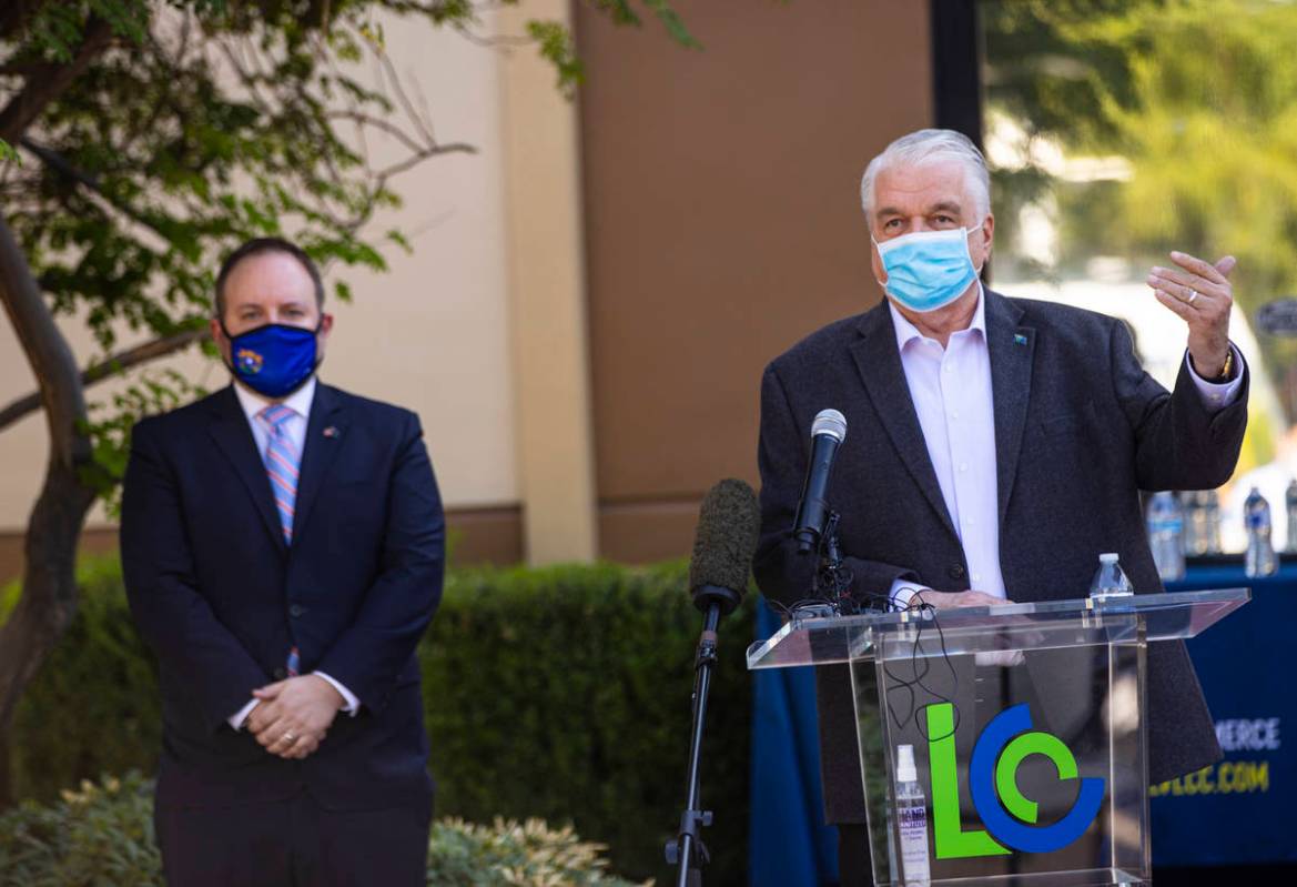 Gov. Steve Sisolak, right, speaks alongside Nevada State Treasurer Zach Conine during a press c ...