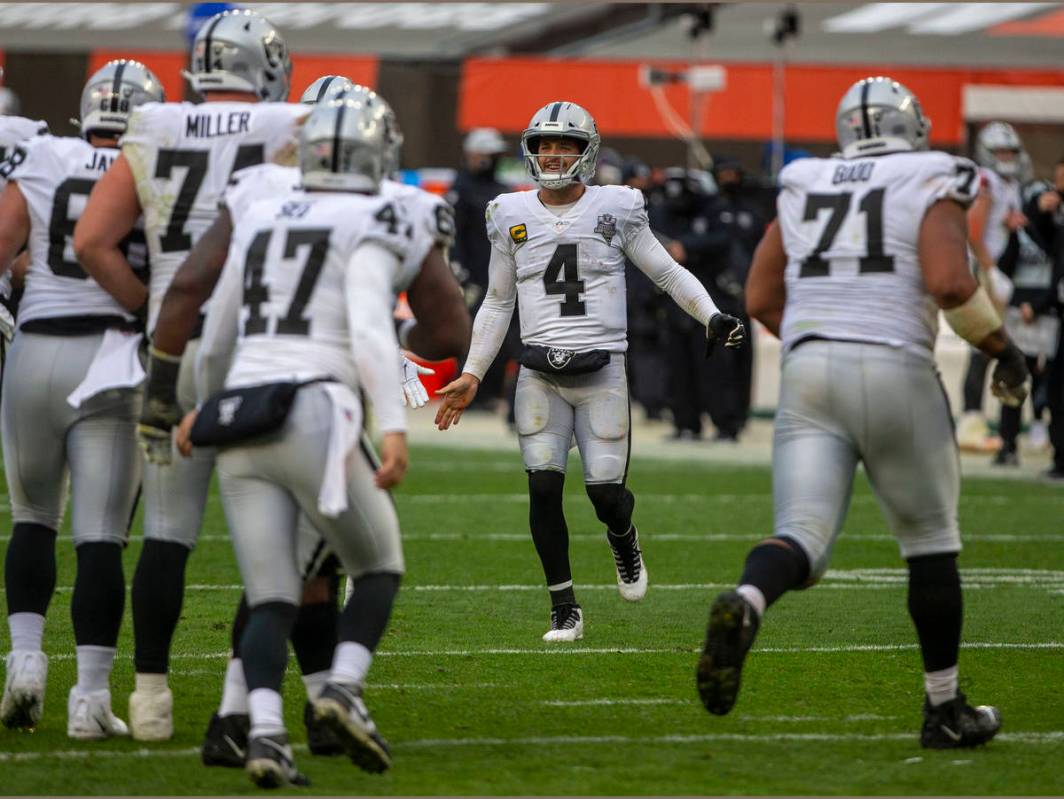 Las Vegas Raiders quarterback Derek Carr (4) comes on the field to congratulate the special tea ...