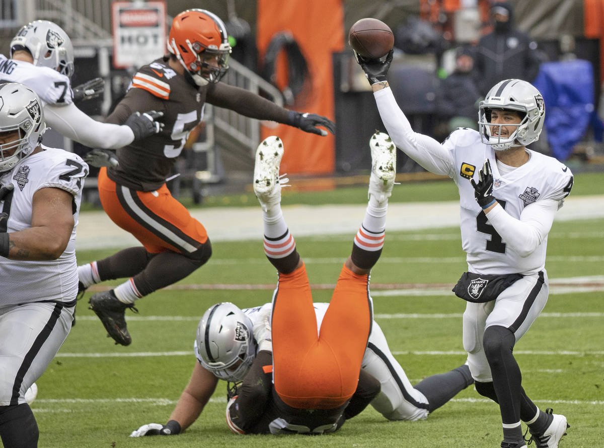 Las Vegas Raiders quarterback Derek Carr (4) makes a throw around pressure from Cleveland Brown ...