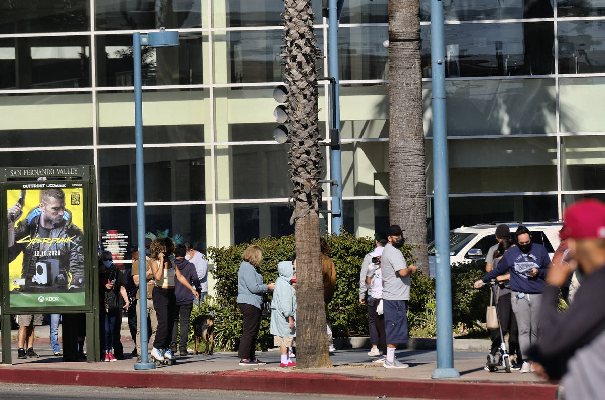 People wait in line to be tested at an outside COVID-19 testing site in the North Hollywood sec ...
