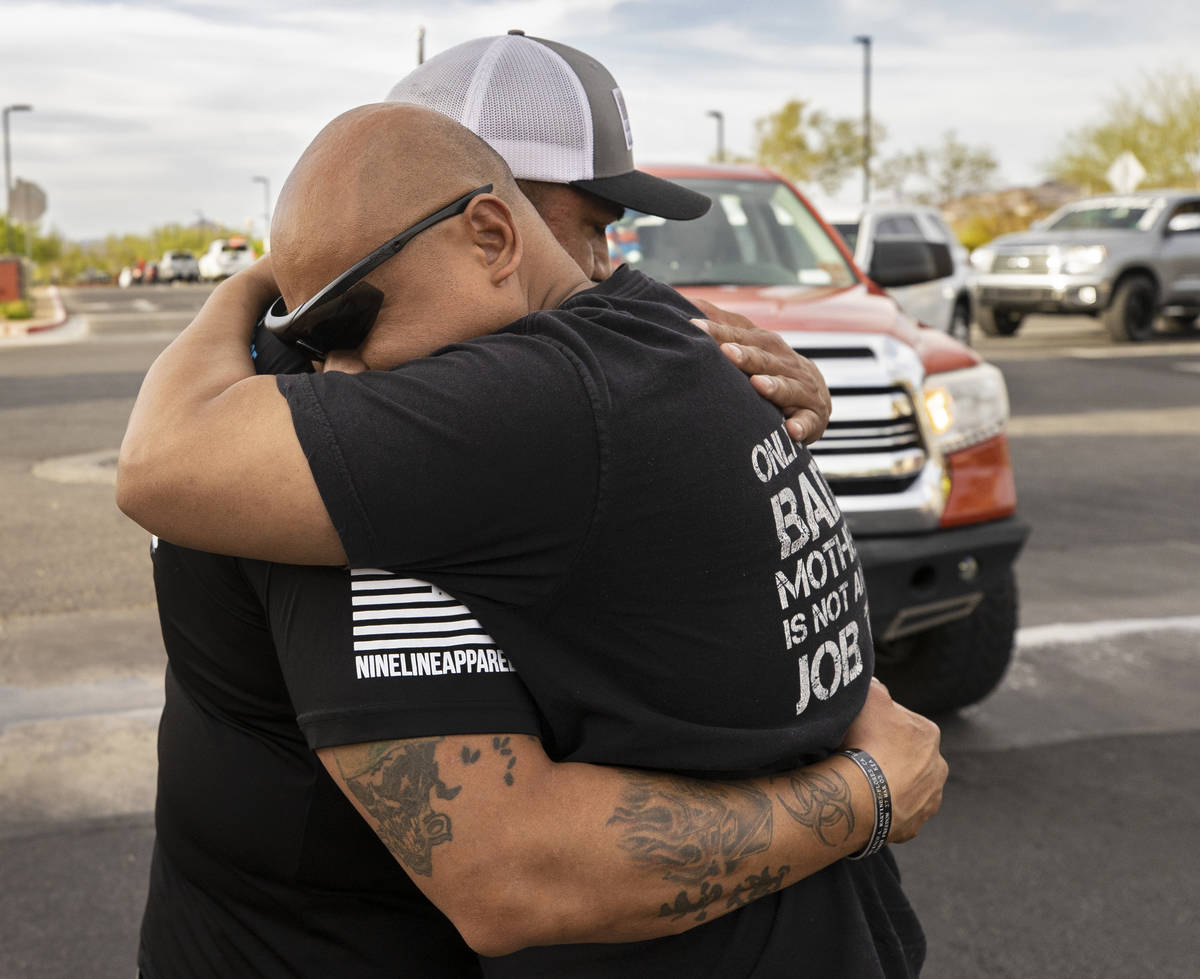 Richard Velasquez, left, father of Aaliyah Velasquez, gets a hug from a Sin City Tundras member ...