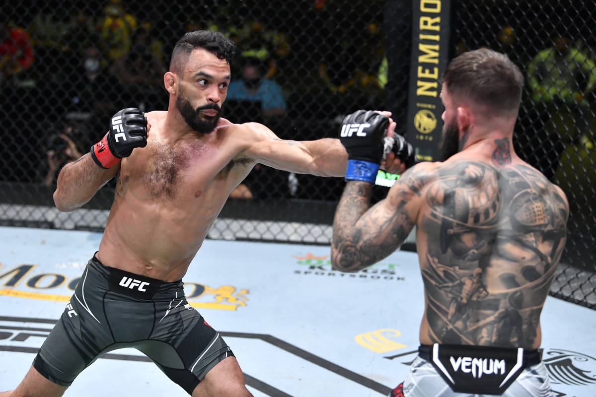 Rob Font punches Cody Garbrandt in their bantamweight bout during the UFC Fight Night event at ...