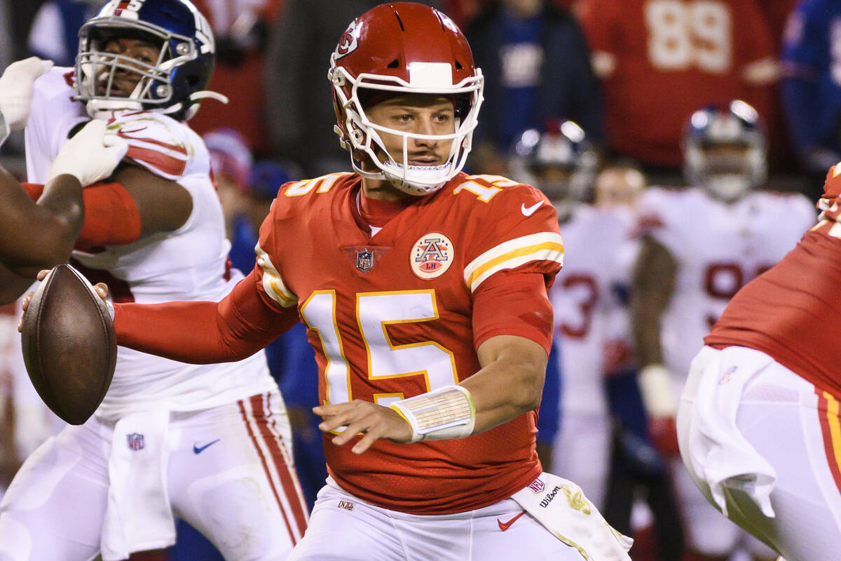 Kansas City Chiefs quarterback Patrick Mahomes (15) scrambles away from pressure during the fir ...