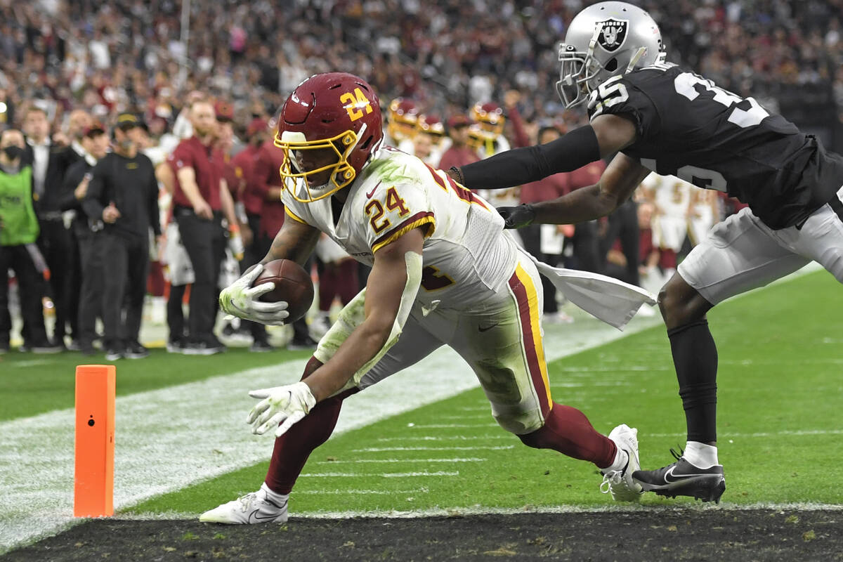 Washington Football Team running back Antonio Gibson (24) scores a touchdown around Las Vegas R ...