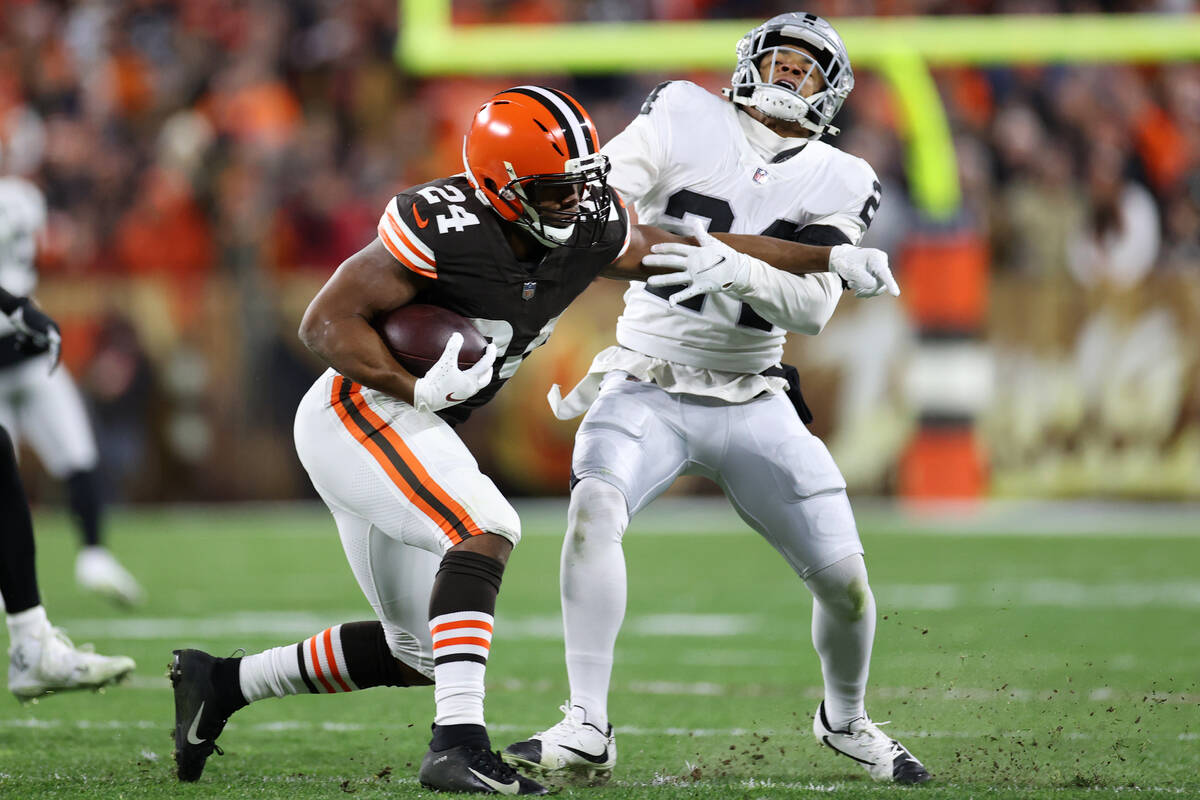 Cleveland Browns running back Nick Chubb (24) stiff arms Raiders safety Johnathan Abram (24) wh ...