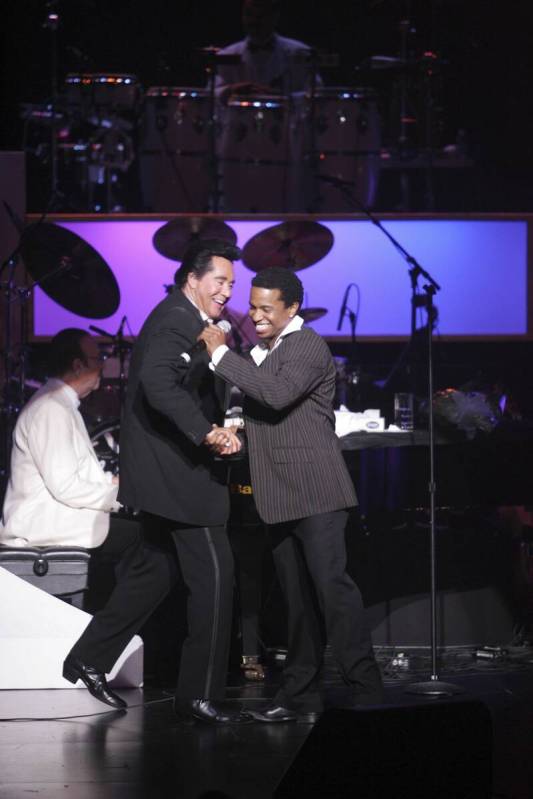 Wayne Newton greets Delisco, aka James Beeks, on stage during Newton's at the Las Vegas Hilton ...