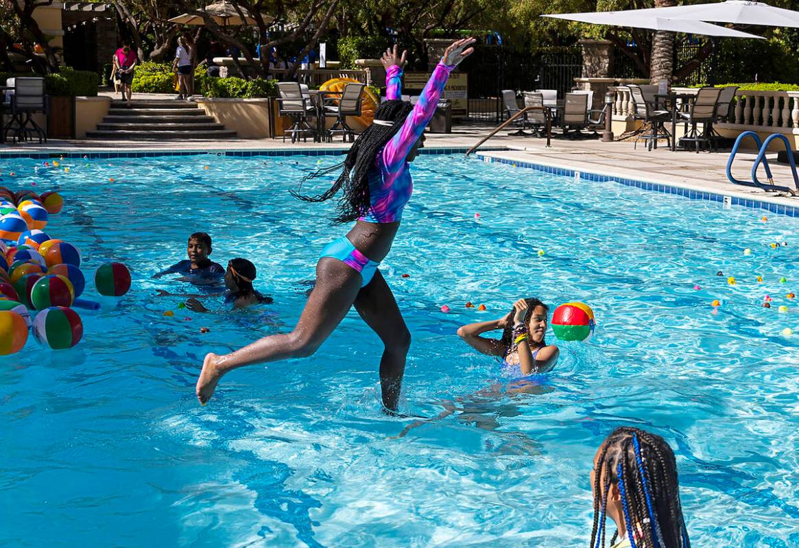 Children play in the pool during a celebratory pancake breakfast and pool party held by the Oly ...