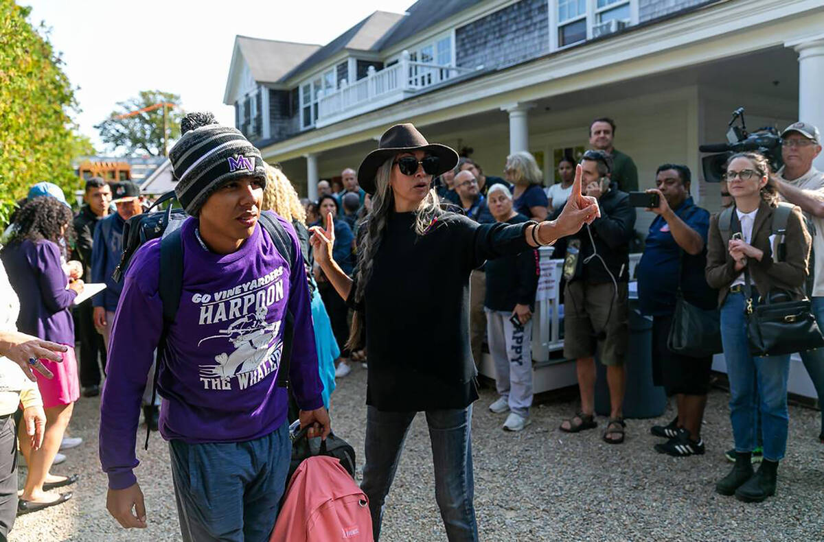 A Venezuelan migrant is led onto a bus at St. Andrews Episcopal Church on Friday, Sept. 16, 202 ...