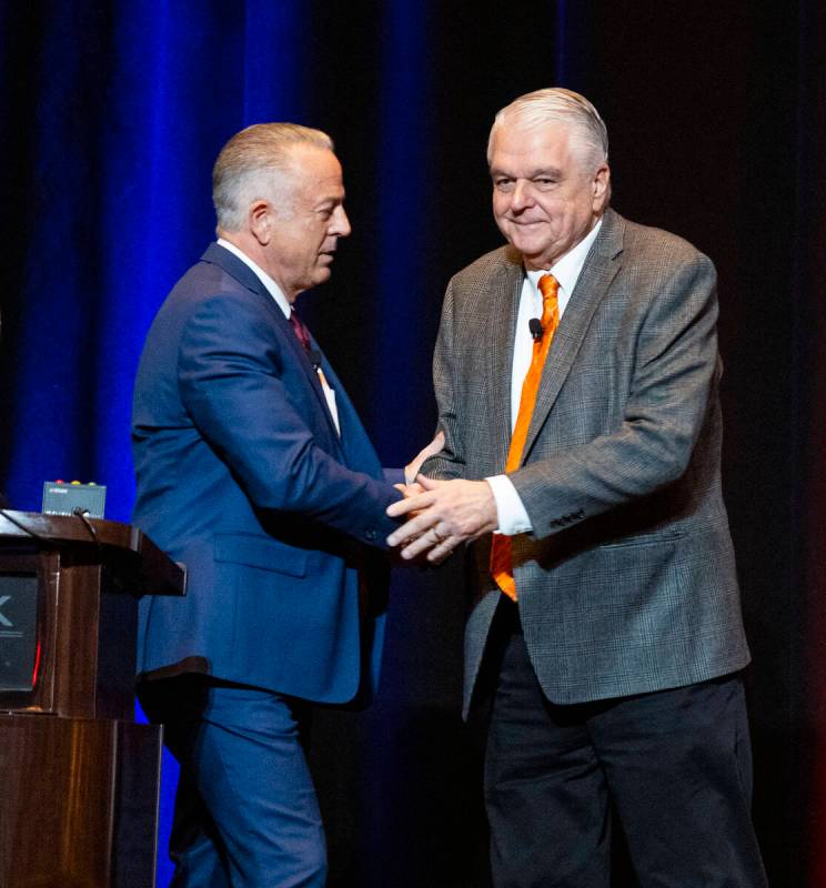 Gov. Steve Sisolak, right, and Sheriff Joseph Lombardo shake hands before meeting with the cons ...