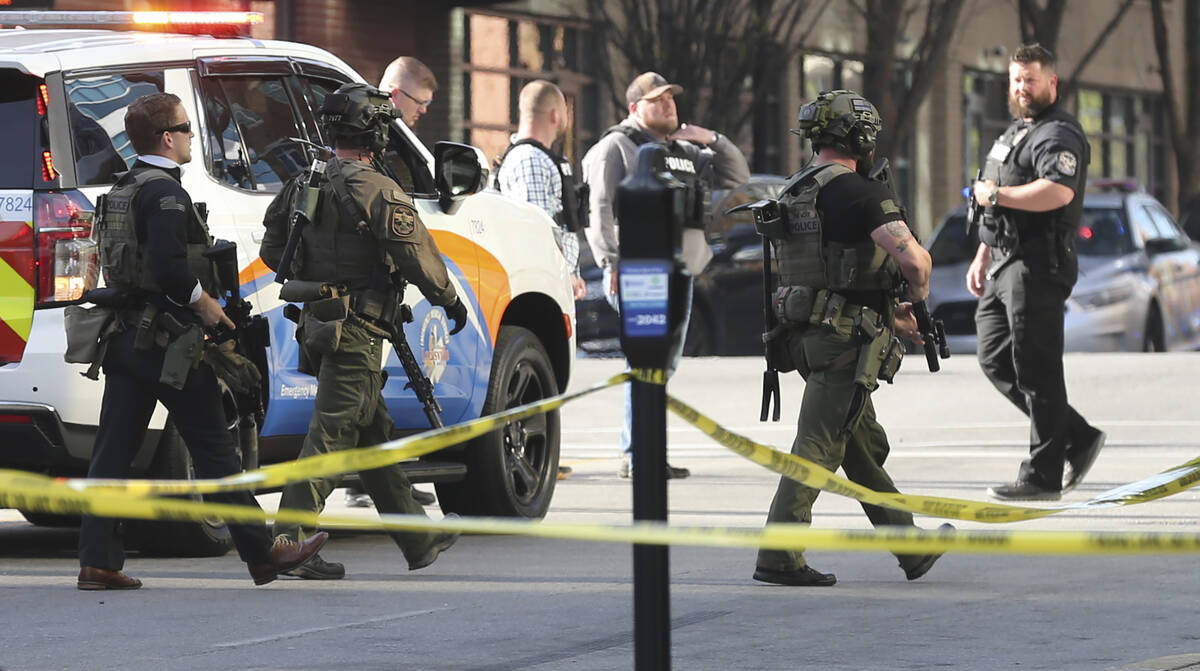 Multiple agencies arrive at a building after a shooting took place in Louisville, Ky., Monday, ...