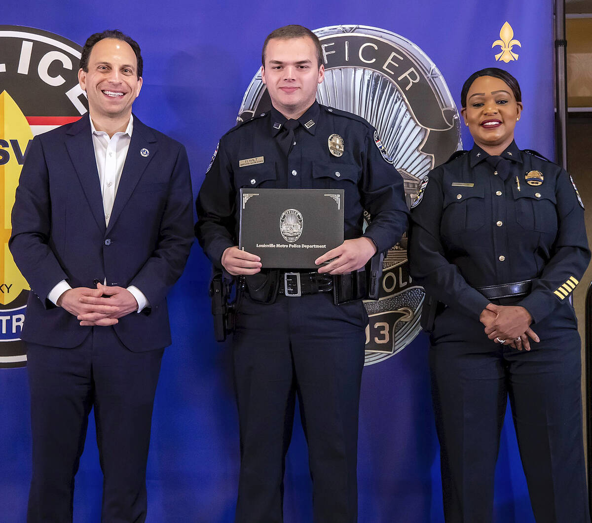 In this photo provided by the Louisville Metro Police Department, from left, Louisville Mayor C ...