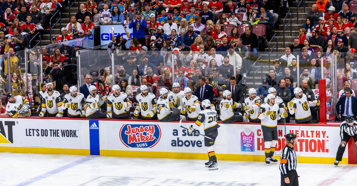 Golden Knights center Chandler Stephenson (20) with teammates celebrate his first goal in perio ...