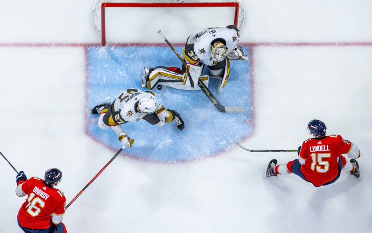 Golden Knights goaltender Adin Hill (33) stops a shot by Florida Panthers center Aleksander Bar ...