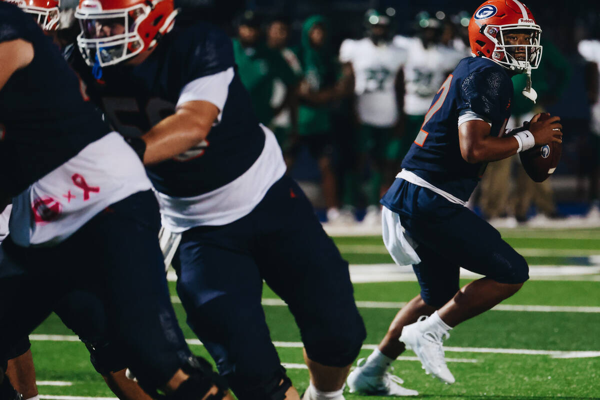 Bishop Gorman quarterback Micah Alejado (12) looks to pass the ball to a teammate during a game ...