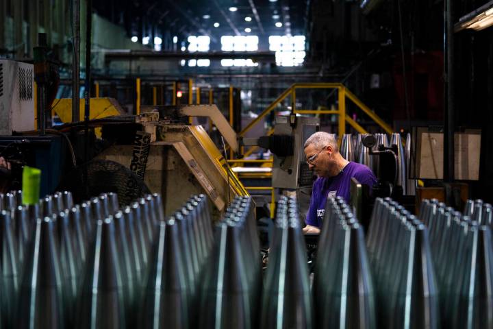 A steel worker manufactures 155 mm M795 artillery projectiles at the Scranton Army Ammunition P ...