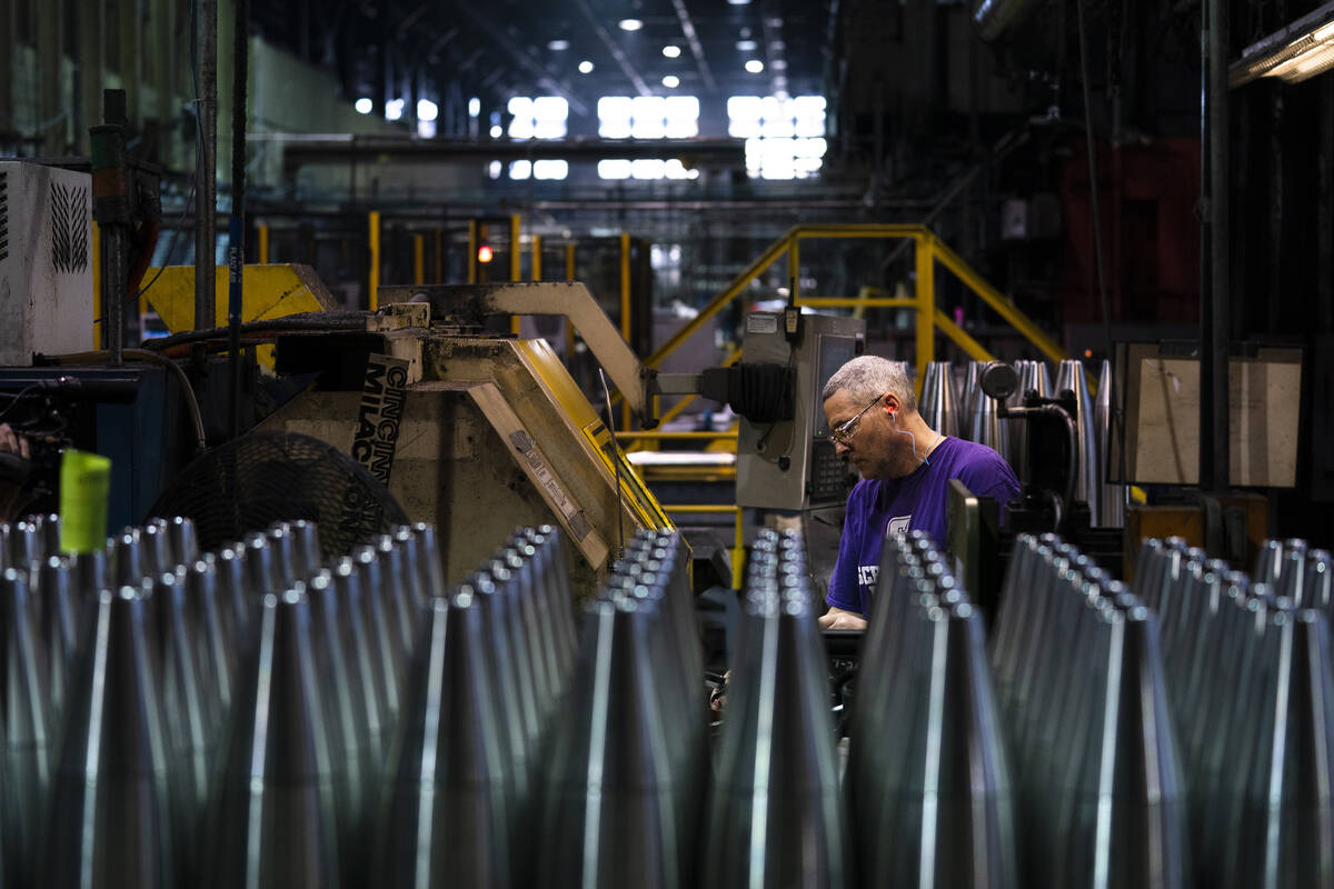 A steel worker manufactures 155 mm M795 artillery projectiles at the Scranton Army Ammunition P ...