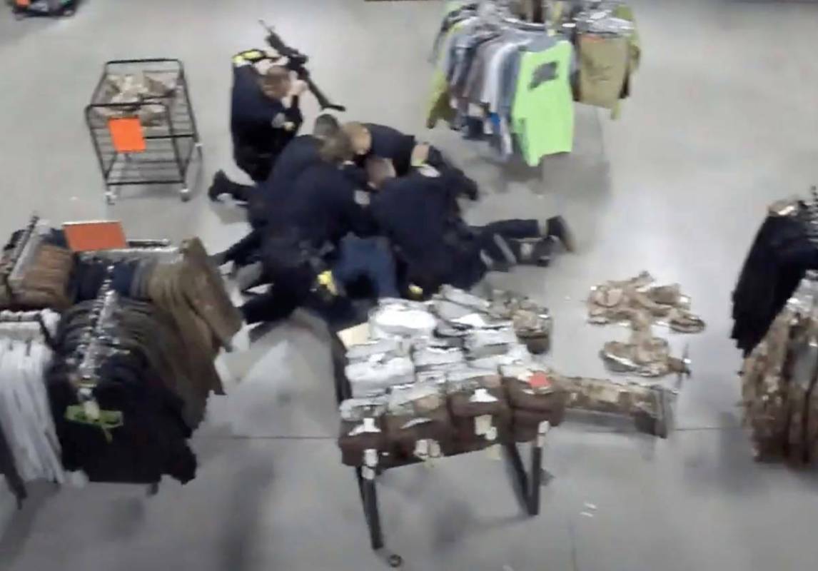 Screenshot from Sportsman's Warehouse surveillance video of Henderson Sgt. Michael Gillis using ...