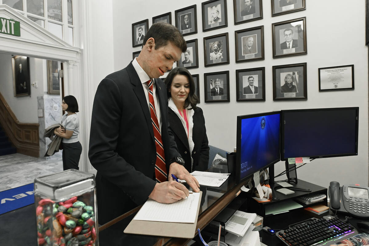 Republican U.S. Senatorial candidate Sam Brown, with his wife Amy Brown, signs in at the Secret ...