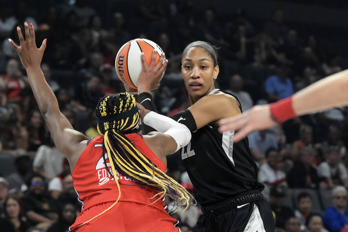 Las Vegas Aces center A'ja Wilson (22) is defended by Washington Mystics forward Aaliyah Edward ...