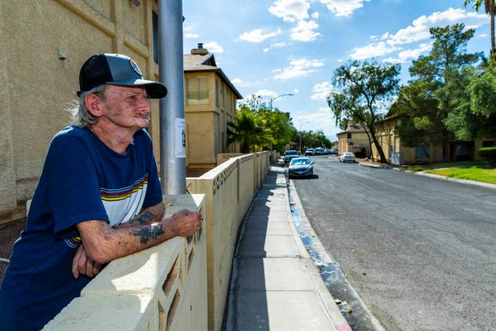 Resident Winfred Cooch enjoys a smoke along Natalee Drive in the Somerset Park community where ...