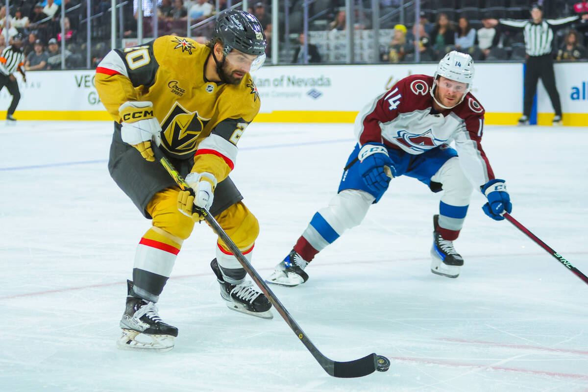 Golden Knights center Zach Aston-Reese (20) moves the puck as Colorado Avalanche right wing Chr ...