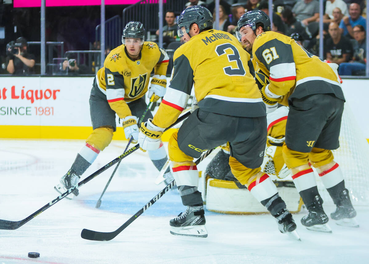 Golden Knights players scurry around the puck during the second period of a preseason NHL hocke ...