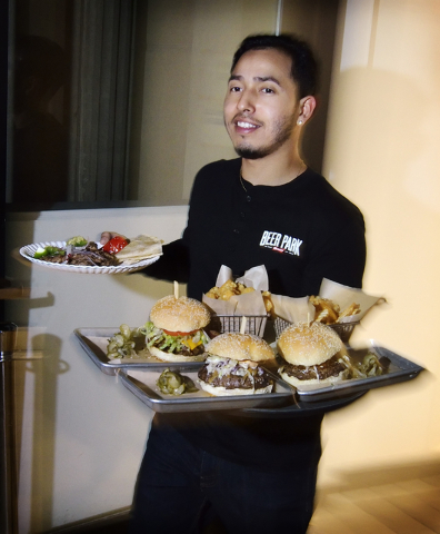 Server Martin Pedroza carries orders to a table at the Beer Park in the Paris hotel-casino at 3655 Las Vegas Blvd. South in Las Vegas on Saturday, March 12, 2016. Bill Hughes/Las Vegas Review-Journal