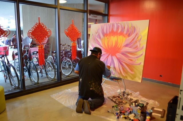 Miguel Hernandez, the full-time resident artist for Zappos, works on a pieces inside the company's downtown Las Vegas headquarters. Ginger Meurer/Special to View