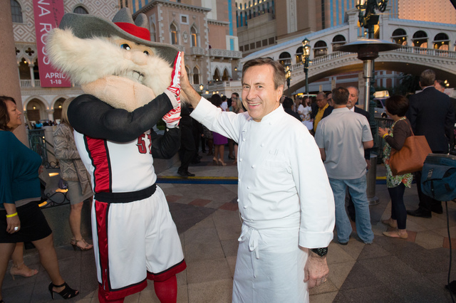Chef Daniel Boulud, shown high-fiving UNLV mascot Hey Reb, received the prestigious Dom Perignon Award of Excellence during UNLVino’s Bubble-Licious at The Venetian April 16, 2015.  (Special to  ...