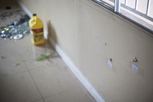 Bullet holes are seen Monday, April 25, on an inside wall of the house at the 2400 block of Page Street where a 24-year-old man was found shot to death early Sunday morning in North Las Vegas. Rac ...
