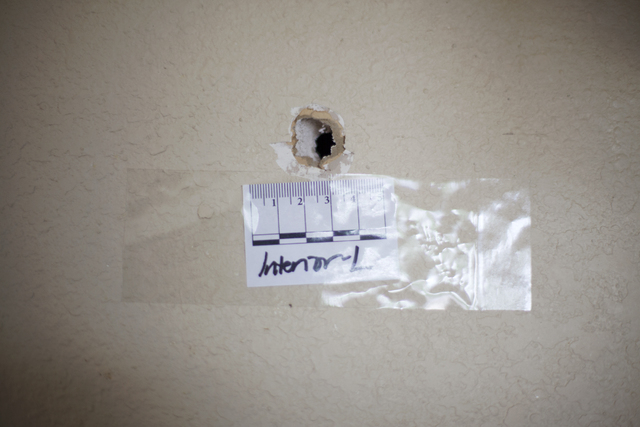 A bullet hole is seen Monday, April 25, on an inside wall of the house at the 2400 block of Page Street where a 24-year-old man was found shot to death early Sunday morning in North Las Vegas. Rac ...