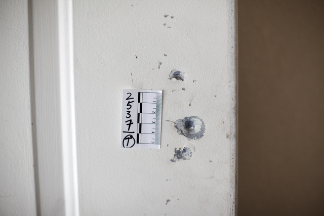 Bullet holes are seen Monday, April 25, on a door of the house at the 2400 block of Page Street where a 24-year-old man was found shot to death early Sunday morning in North Las Vegas. Rachel Asto ...