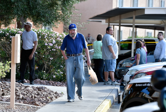 People congregate as Las Vegas police investigate an apparent stabbing at the Sunridge Apartments along East Vegas Valley Drive near Nellis Boulevard Monday, May 16, 2016, in Las Vegas. David Beck ...