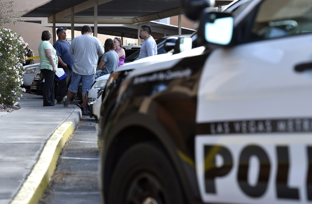 People congregate as Las Vegas police investigate an apparent stabbing at the Sunridge Apartments along East Vegas Valley Drive near Nellis Boulevard Monday, May 16, 2016, in Las Vegas. David Beck ...