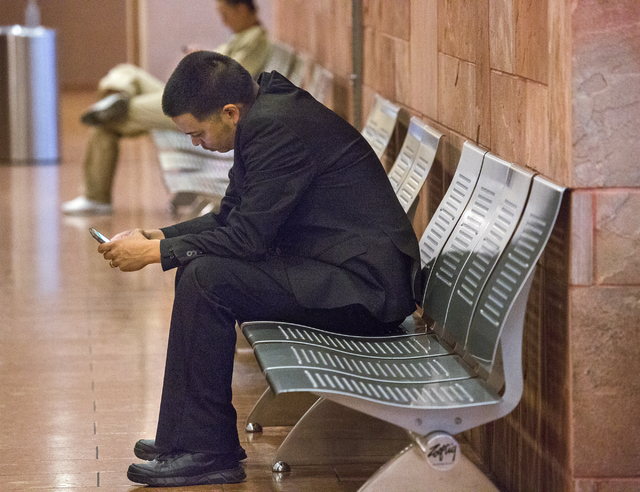 Raynaldo Ramos, a High Desert Prison trainee charged in fatal shooting of inmate, sits outside the courtroom after making his initial court appearance, Wednesday, May 18, 2016, at Regional Justice ...
