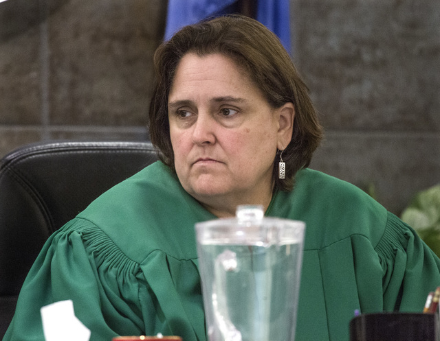 District Judge Kathleen Delaney listens while Philip Morris, father of murder victim 10-year-old Jade Morris, makes a victim's statement in the sentencing of convicted murder Brenda Stokes Wilson  ...