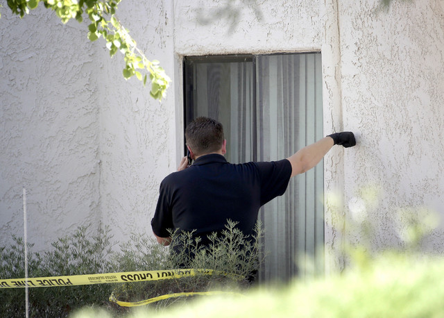 A Phoenix police detective stands outside a home, Thursday, June 2, 2016, where three boys Wednesday night.  The boy's mother was hospitalized in critical condition with self-inflicted stab wounds ...