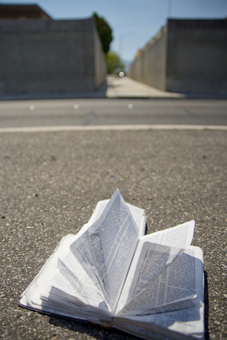 A bible lies open on the pavement in front of an alleyway near Smoke Ranch Road and Jones Boulevard in Las Vegas is seen on Saturday, June 4, 2016. A shooting took place in the early hours of Satu ...
