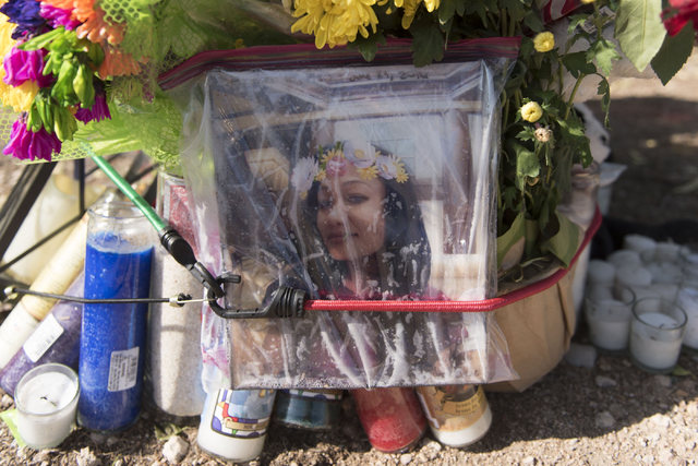 A memorial for Phoukeo Dej-Oudom, one of the victims of Wednesday night's quadruple murder-suicide, is seen in the parking lot of Walgreens Pharmacy on Lake Mead Boulevard and Jones Boulevard in L ...