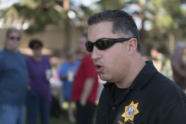 Las Vegas police Lieutenant Nicholas Farese speaks with a reporter during an outreach event held at Torrey Pines Condominiums following Wednesday night's quadruple murder-suicide of a family in La ...