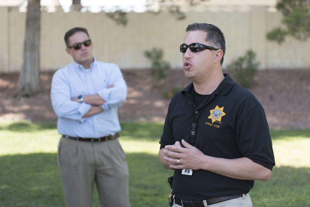 Las Vegas police Lieutenant Nicholas Farese, right, speaks to attendees during an outreach event held at Torrey Pines Condominiums following Wednesday night's quadruple murder-suicide of a family  ...