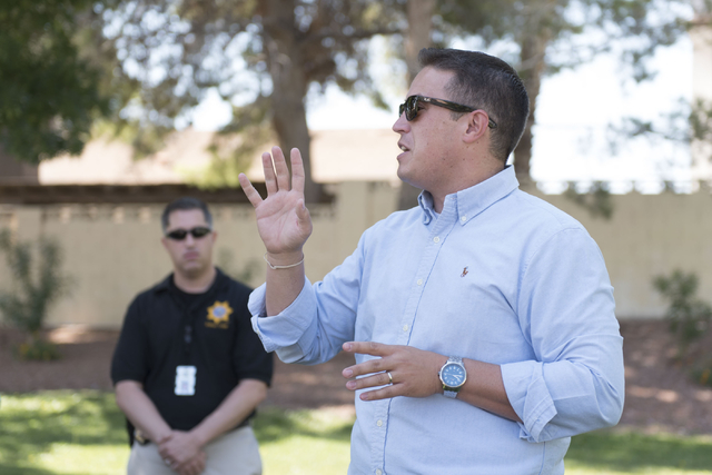 Pastor Matt Teis of Liberty Baptist Church, right, speaks to attendees during an outreach event held at Torrey Pines Condominiums following Wednesday night's quadruple murder-suicide of a family i ...