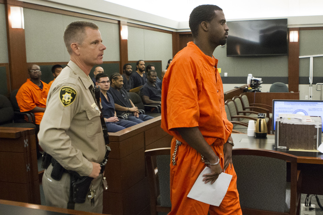 Davon Sebastian Phillips, charged in the 2009 shooting death of 16-year-old Aric Brill, is exported out of the courtroom after his appearance at the Regional Justice Center on Wednesday, July 13,  ...