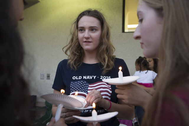 Mary Jane Bell, 15, pays her respects at a candlelight vigil for the victims of a murder-suicide on Friday, July 1, 2016 in Las Vegas. Loren Townsley/ Las Vegas Review-Journal Follow @LorenTownsley