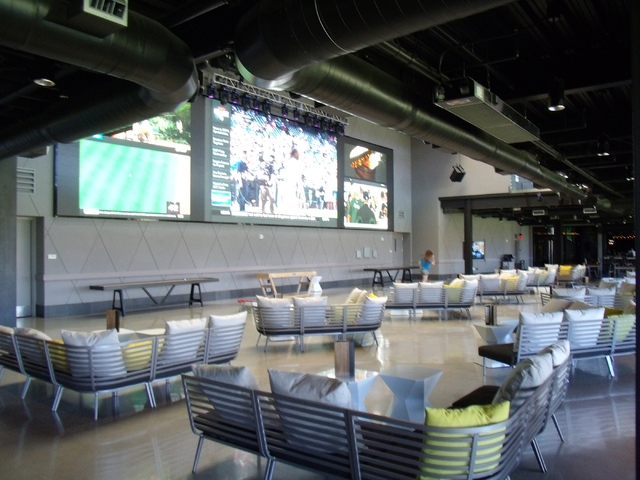 Large-screen TVs broadcast games at Topgolf, 4627 Koval Lane. John Asay/Special to View