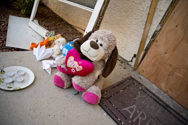 Toys and other items placed by local residents, sit outside the boarded apartment where Jason Dej-Oudom killed himself and his three children on Wednesday night on Friday, July 1, 2016. Dej-Oudom  ...