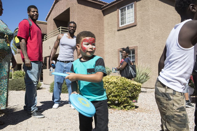 William Crishon, 5, plays frisbee during an event for the residents of Avery Park apartments held by Victory Outreach Summerlin and LVMPD Bolden Area Command on Saturday, Sept. 24, 2016, in Las Ve ...