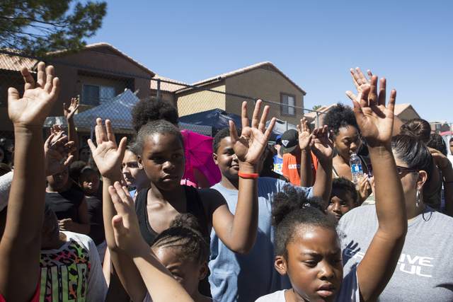 Attendees raise their hands in support of God during a sermon at Avery Park apartments on Saturday, Sept. 24, 2016, in Las Vegas. Loren Townsley/Las Vegas Review-Journal Follow @lorentownsley